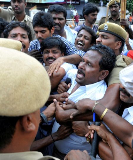 Policemen prevent an AIADMK supporter who tried to immolate himself in Coimbatore in protest over Jayalalithaa's conviction. Photograph: PTI photo