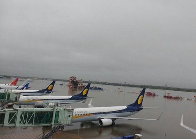 Aircraft stranded at the flooded Chennai airport. Photograph: @harikiranroyal/Twitter
