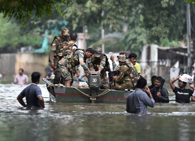 Army personnel rescue residents from a flooded area in Chennai. Photograph: PTI