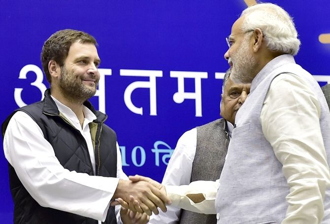 Prime Minister Narendra Damodardas Modi greets Congress President Rahul Gandhi as Samajwadi Party leader Mulayam Singh Yadav looks on