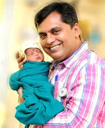 Dr Ganesh Rakh with a new-born baby girl