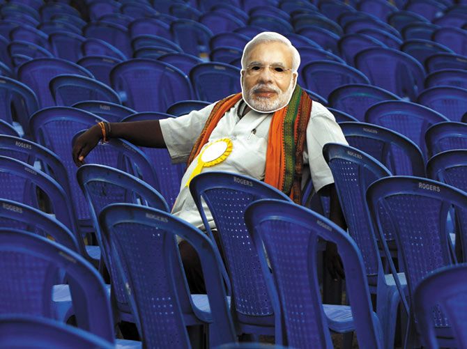 A man wears a Modi mask at a campaign rally in Chennai.