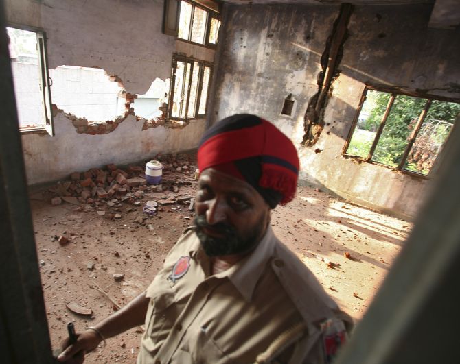 A policeman stands inside the damaged Dinanagar police station in Gurdaspur. Photograph: Munish Sharma/Reuters
