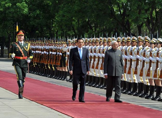 Narendra Modi inspects a guard of honour in Beijing