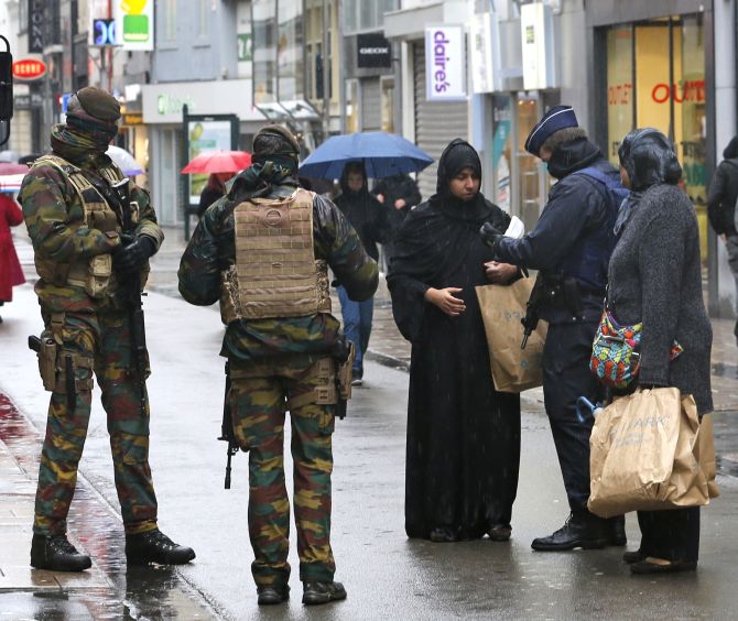 Belgian security personnel check the documents of a Muslim woman in central Brussels, last November, soon after the Paris attacks. Photograph: Youssef Boudlal/ Reuters