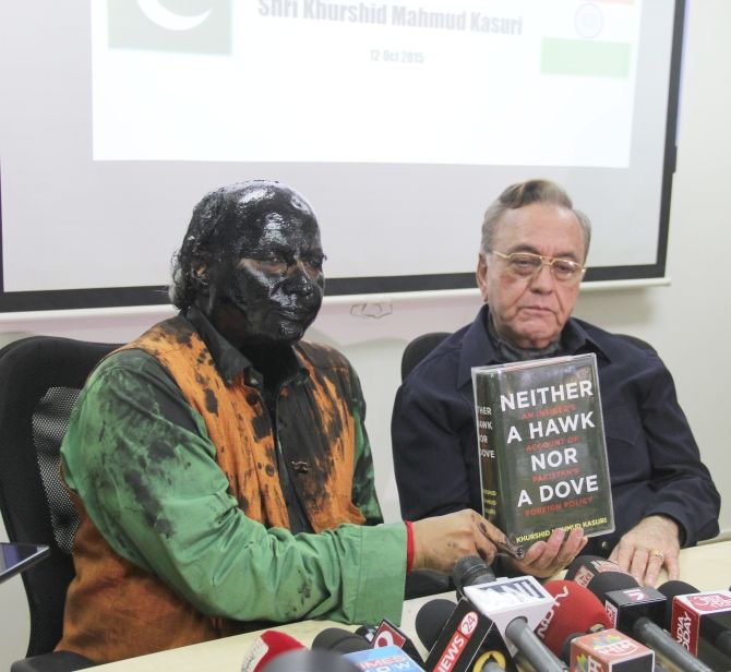 Author-journalist Sudheendra Kulkarni, left, after Shiv Sainiks hurled paint and ink on him for hosting a book release event featuring former Pakistan foreign minister Khurshid Kasuri, right.