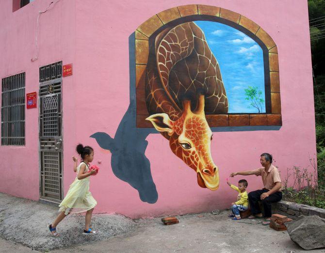 Tourists Play In Front Of A 3D Painting On The Wall House Luoyuan Village Jinhua Zhejiang Province Hired Team To Put Tourists Play In Front Of A 3D Painting On The Wall House Luoyuan Village Jinhua Zhejiang Province Hired Team To Put