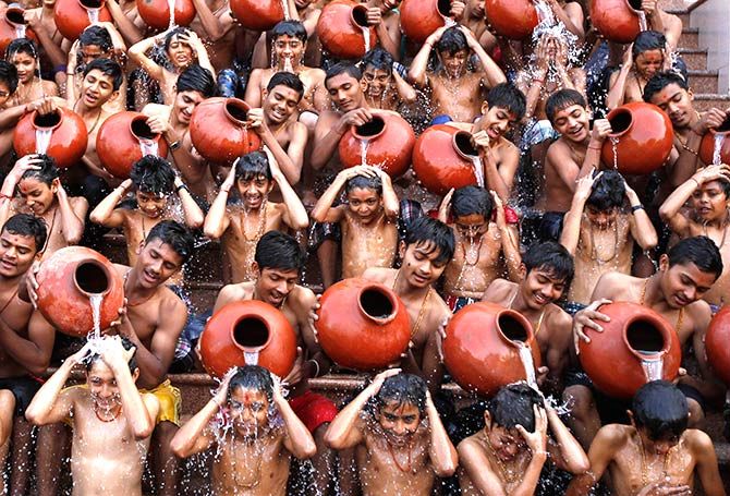 Students pour water on each other as they take a holy bath on the occasion of Magh Purnima in Ahmedabad, January 16, 2014. Photograph: Amit Dave/Reuters