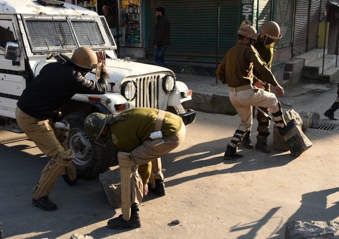 Security personnel remove boulders from a deserted street. The separatists have called for a shutdown to protest the four deaths when the army allegedly opened fire. Photograph: S Irfan/PTI