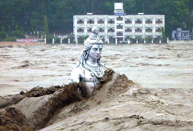 A submerged statue of Lord Shiva stands amid the flooded waters of river Ganges at Rishikesh in 2013.