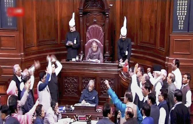 A TV grab of members protesting in the Rajya Sabha during the winter session of Parliament