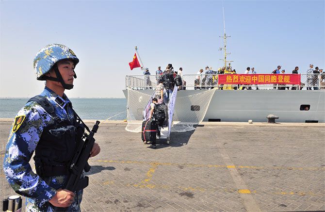 Chinese citizens from Yemen board the naval ship <em>Linyi</em> at a port in Aden, March 29, 2015.  They were transported across the Red Sea to Djibouti to be flown home. Photograph: Reuters