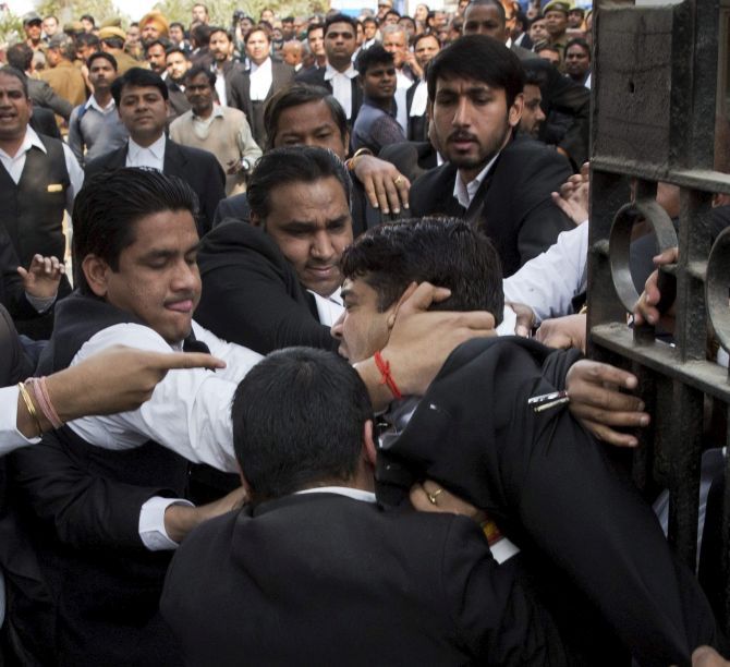 Lawyers attack one another and media persons outside Patiala House court in New Delhi on Wednesday. Photograph: PTI