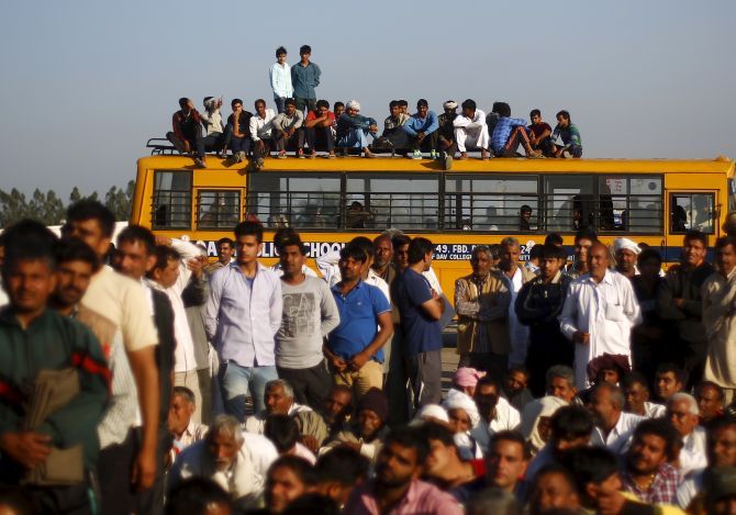 Jat demonstrators atop a school bus at Sampla village in Haryana block the Delhi-Haryana national highway. Photograph: Adnan Abidi/Reuters