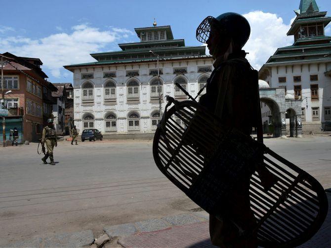 Security personnel on a deserted Srinagar street. Photograph: Umar Ganie