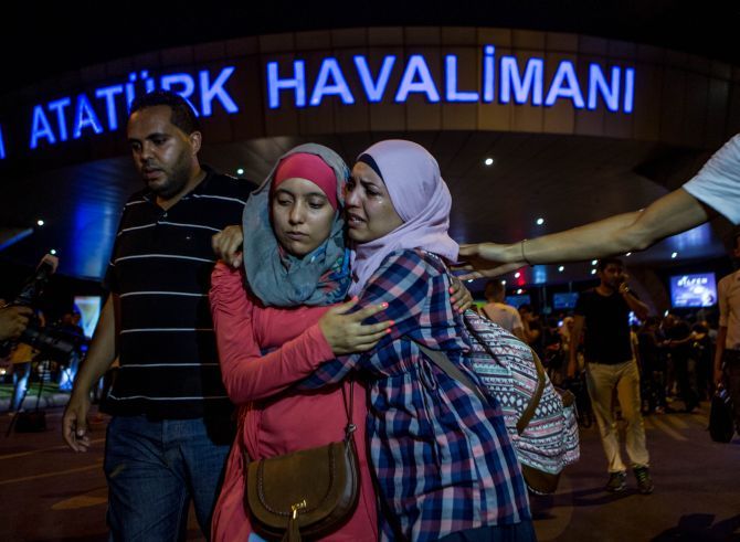 IMAGE: Passengers leave Istanbul Ataturk, Turkey's largest airport, after a suicide bomb attack. Photograph: Defne Karadeniz/Getty Images