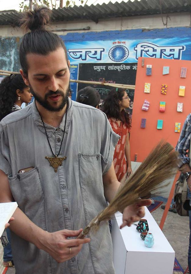 Rubio with a broom at the Design Museum Dharavi.