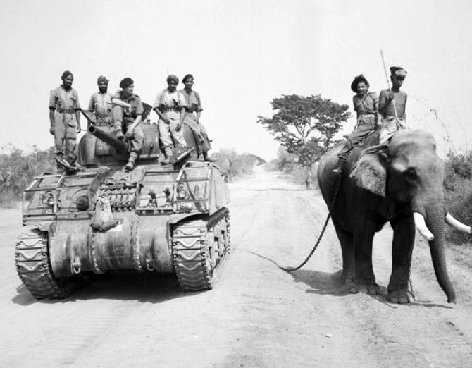 The British commander and Indian crew of a Sherman tank of the 9th Royal Deccan Horse, 255th Indian Tank Brigade, encounter a newly liberated elephant on the road to Meiktila, Burman, March 29, 1945. Photograph: Sergeant A Stubbs/ No 9 Army Film &amp; Photographic Unit, from the collection of the Imperial War Museum.
