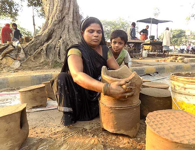 Muslim women making handmade earthen stoves for Chhath