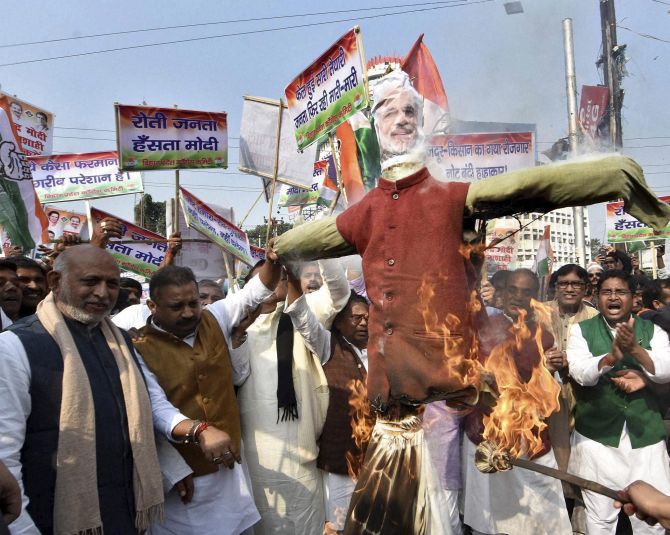 Congress workers burn an effigy of Prime Minister Narendra Modi during a protest against demonetisation in Patna.