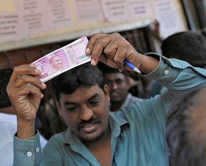 A man with a Rs 2000 note