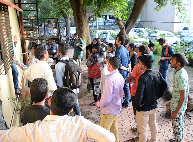 Employees of the Delta IT Park call centre waiting for questioning outside the Thane Crime Branch office for their turn. While 70 people have been arrested the rest were released after being asked to present themselves for questioning as and when required.