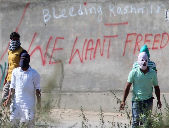 Youth pelt stones on Police during clashes.