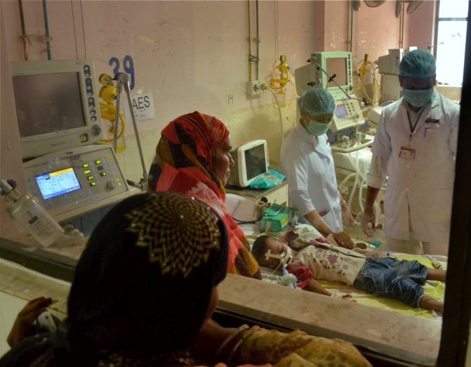 Parents watch their children being treated for encephalitis at the BRD hospital. Photograph: PTI Photo