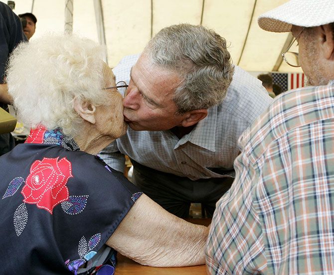  George W Bush kisses Helen Dedeaux, 94, while visiting Hurricane Katrina's victims in Gulfport, Mississippi, September 12, 2005.