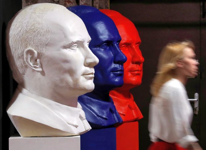Busts depicting Russian President Vladimir Putin in the colours of the Russian flag at the SUPERPUTIN exhibition. Photograph: Maxim Shemetov/Reuters