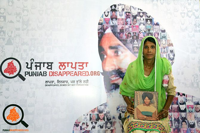 A family member with a photograph of a person who went missing in Punjab during the troubled years. Photograph: Kind courtesy Punjab Disappeared.org