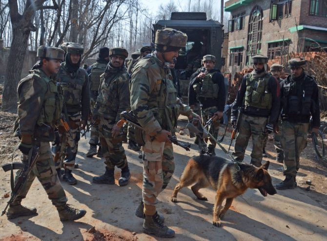 Soldiers conduct search operations, February 12, 2017, after four terrorists, two army personnel and a civilian were killed in a fierce gunfight in a village in south Kashmir. Photographs: Umar Ganie