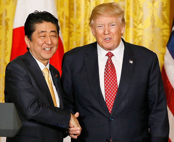 US President Donald Trump, right, with Japanese Prime Minister Shinzo Abe