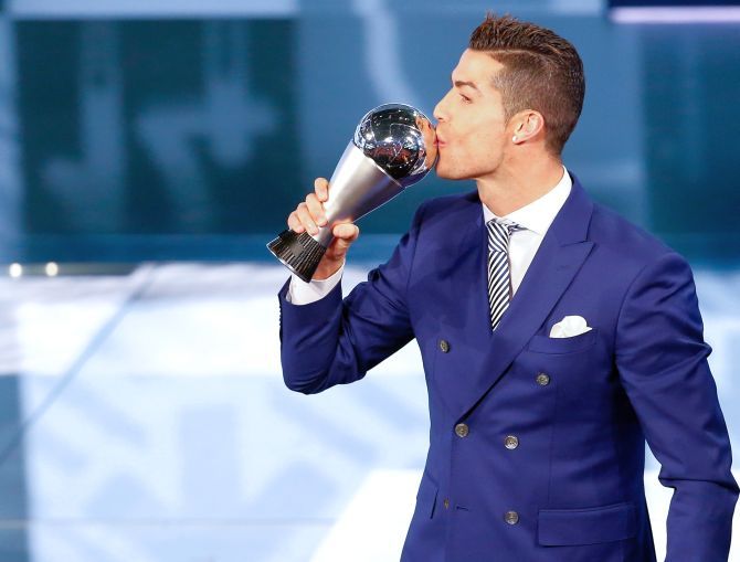 Cristiano Ronaldo celebrates with the trophy. Photograph: Ruben Sprich/Reuters
