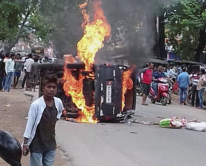 A vehicle torched during a protest against the lynching of a meat trader in Ramgarh district, Jharkhand. Photograph: PTI Photo