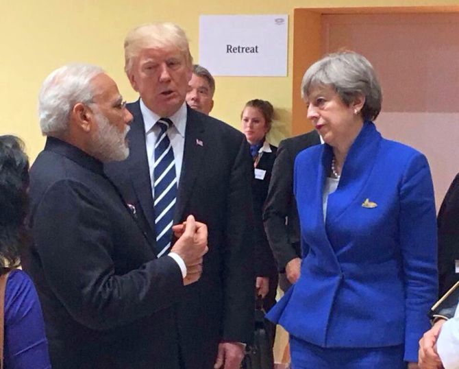 Prime Minister Narendra D Modi chats with US President Donald J Trump and Britain's Prime Minister Theresa May At the G-20 summit in Hamburg. Photograph: @MEAIndia/Twitter