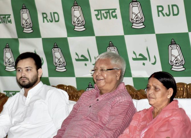Former Bihar chief ministers Lalu Prasad Yadav, centre, and  Rabri Devi, right, with their son Bihar Deputy Chief Minister Tejashwi Yadav. Photograph: PTI photo