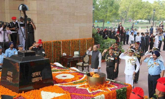 Then defence minister Arun Jaitley with the three service chiefs -- Army Chief General Bipin Rawat, Chief of the Naval Staff Admiral Sunil Lanba, and Air Chief Marshal Birender Singh Dhanoa -- pay homage to Kargil war heroes at the Amar Jawan Jyoti in New Delhi, July 26, 2017. Photograph: Press Information Bureau
