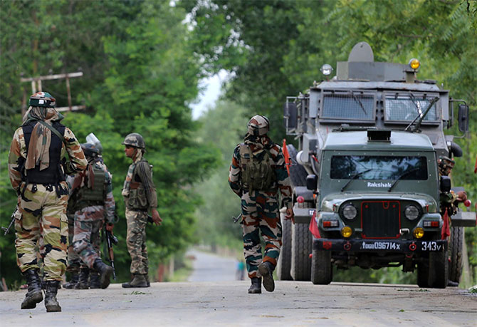 Soldiers rush towards the site of an encounter at a Central Reserve Police Force camp in Bandipore, south Kashmir, June 5, 2017. Four terrorists were slain in the firefight. Photograph: Umar Ganie for Rediff.com