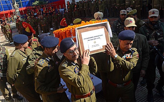 Jammu and Kashmir police officers carry the coffin of Constable Manzoor Ahmed Naik, a resident of Uri, who was killed in an encounter with Hizbul Mujahideen terrorist Aaquib Bhat and Pakistan terrorist Saif-ul-lah in Tral, south Kashmir, March 4/5, 2017. Naik took on the terrorists during the operation, which began at 7 pm on Saturday night and continued till 6.30 am. Photograph: Umar Ganie