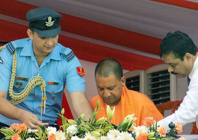 Squadron Leader Praveen Bhoria of the Indian Air Force, the aide-de-camp to Uttar Pradesh Governor Ram Naik, left, assists Chief Minister Yogi Adityanath after the swearing-in ceremony. Photograph: Sandeep Pal