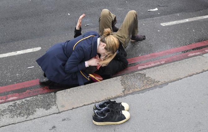 People help an injured person outside Westminister