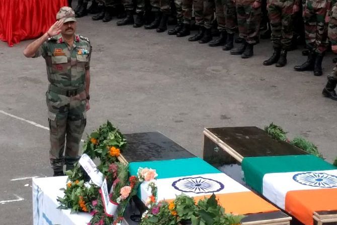 An Indian Army officer pays tribute to a soldier killed by the Pakistan army