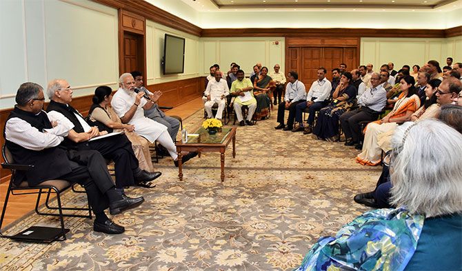 Prime Minister Narendra D Modi, flanked by External Affairs Minister Sushma Swaraj and Surface Transport Minister Nitin J Gadkari, interacts with a group of additional secretaries and joint secretaries in New Delhi, September 1, 2017.