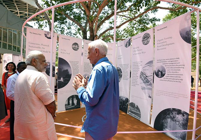 Prime Minister Narendra D Modi interacts with an old-timer at Auroville, February 25, 2018. Photograph: Press Information Bureau