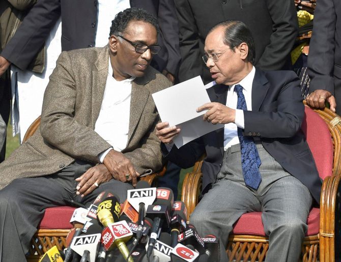 Supreme Court Justice Ranjan Gogoi, right, confers with Supreme Court Justice Jasti Chelameswar at the January 12 press conference in New Delhi. Photograph: Ravi Choudhary/PTI Photo