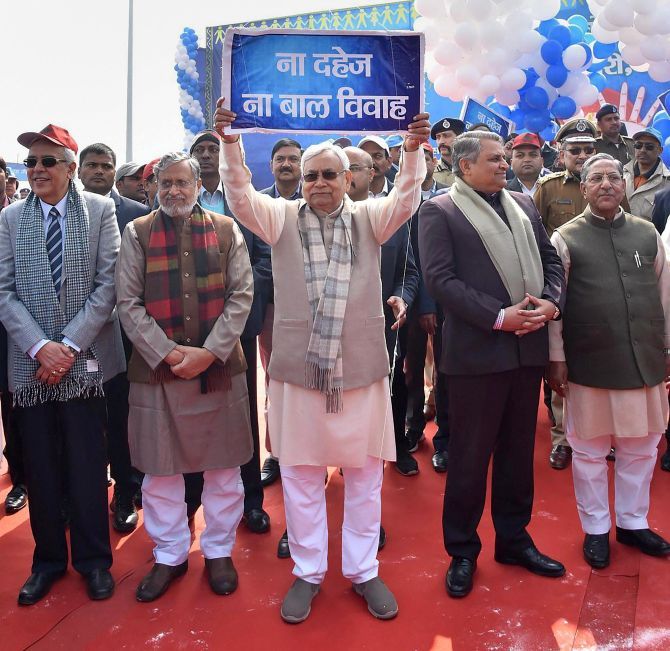 Bihar Chief Minister Nitish Kumar, flanked by Deputy CM Sushil Kumar Modi and assembly Speaker Vijay Chaudhary, leads a human chain against child marriage and dowry in Patna, January 21, 2018. Photograph: PTI Photo