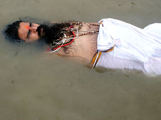 A sadhu takes a dip in the Ganga