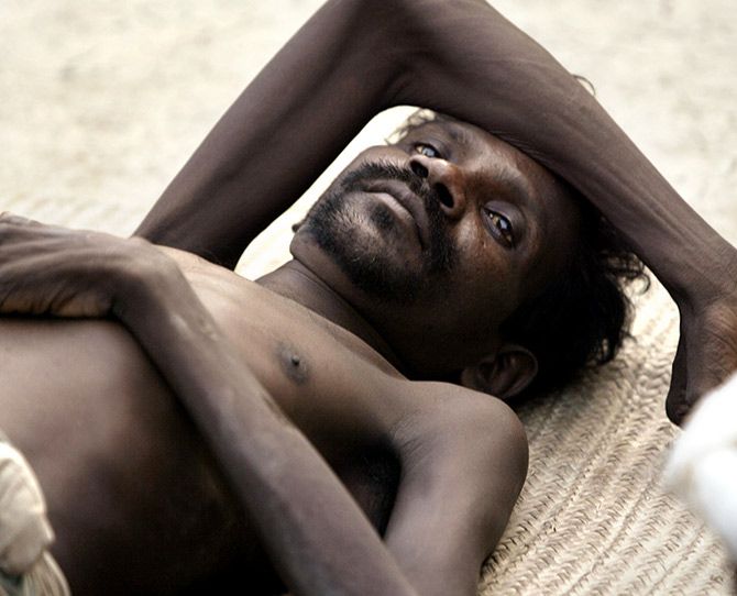 Shontish Hansda, 35, suffering from tuberculosis, lies outside his hut in the village of Mirjapur, some 120 kilometres west of Kolkata. Photograph: Desmond Boylan/Reuters