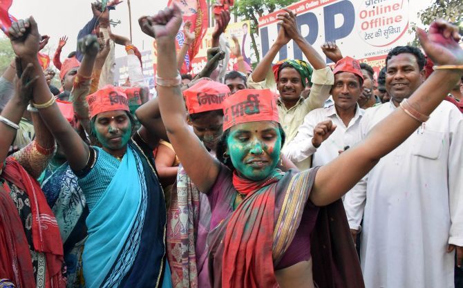 Samajwadi Party workers rejoice after the party shocked the BJP in the Lok Sabha by-elections in Gorakhpur and Phulpur. Photograph: PTI Photo